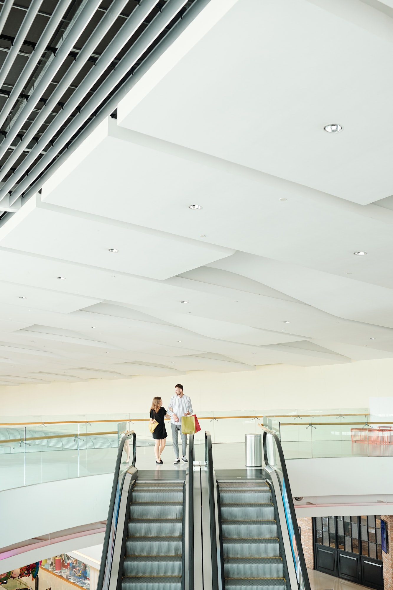 Couple at shopping mall escalator