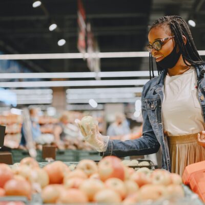 Black girl in a mask buy a food